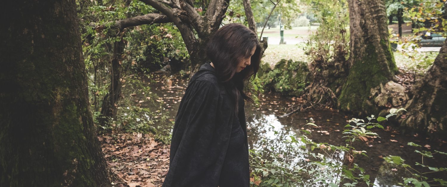 dark woman with black mantl