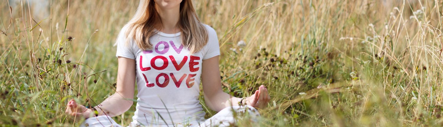 Young girl meditating in the field